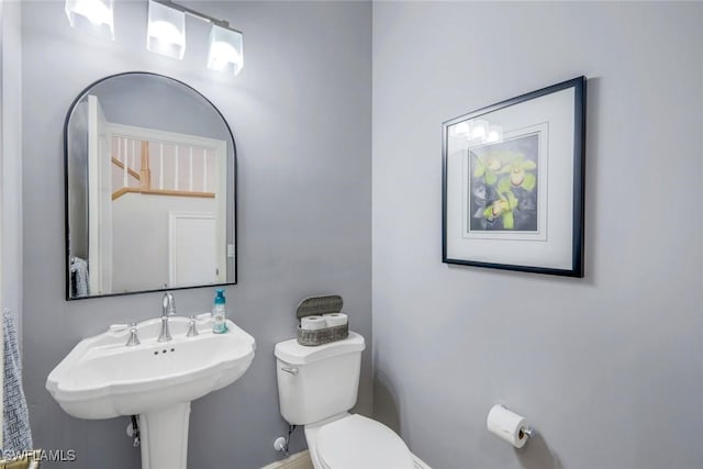 bathroom with toilet and a sink