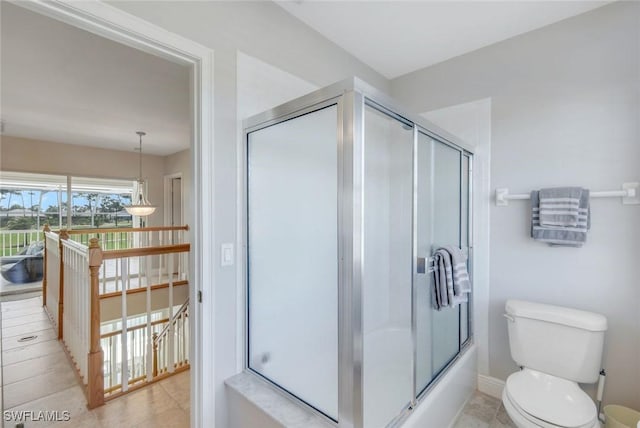 full bathroom with toilet, baseboards, and combined bath / shower with glass door