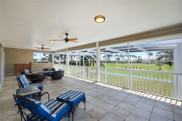 unfurnished sunroom with a ceiling fan