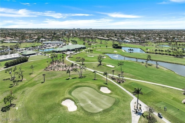 drone / aerial view featuring view of golf course and a water view