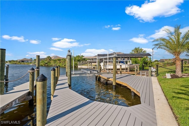 view of dock featuring a water view, boat lift, and fence