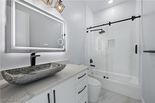 full bathroom featuring enclosed tub / shower combo, marble finish floor, toilet, and vanity