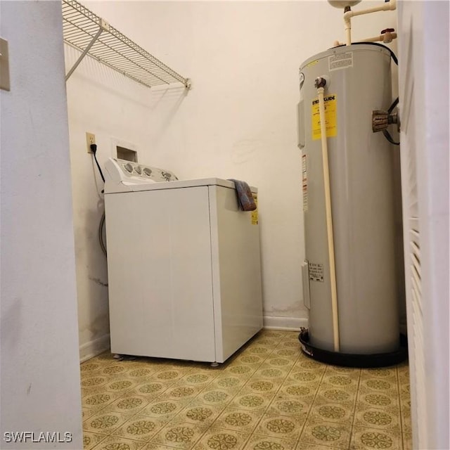 washroom featuring laundry area, baseboards, water heater, and washer / dryer