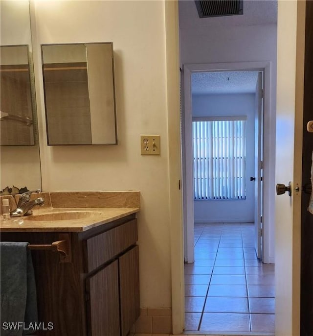 bathroom with tile patterned flooring, visible vents, and vanity