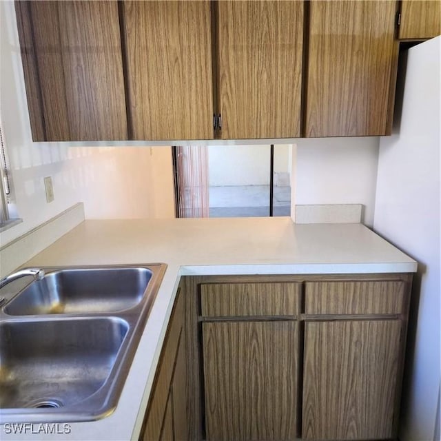 kitchen featuring a sink and light countertops