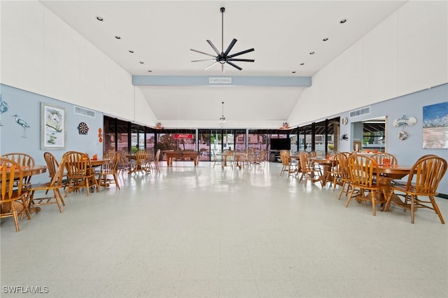 dining room featuring tile patterned floors, visible vents, high vaulted ceiling, and a ceiling fan