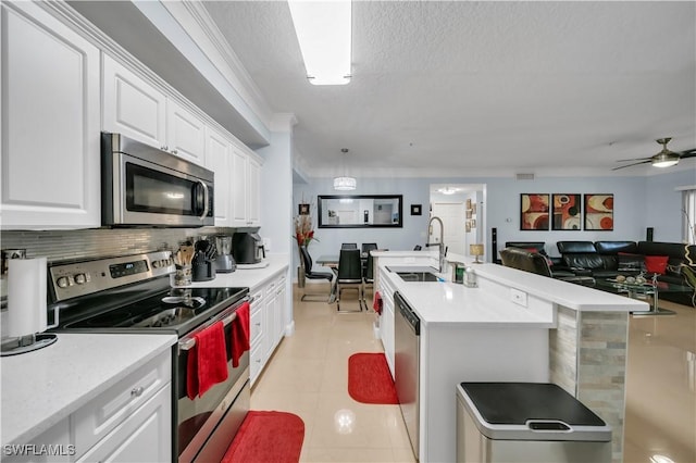 11510 Villa Grand Unit 408, Fort Myers, FL 33913 - kitchen featuring light countertops, a sink, open floor plan, stainless steel appliances, and white cabinets