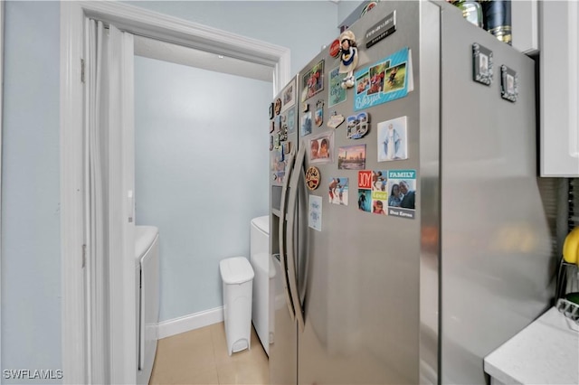 11510 Villa Grand Unit 408, Fort Myers, FL 33913 - bathroom featuring tile patterned floors, toilet, baseboards, and washing machine and clothes dryer