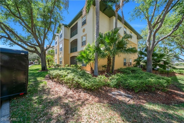 11510 Villa Grand Unit 408, Fort Myers, FL 33913 - view of side of property with stucco siding