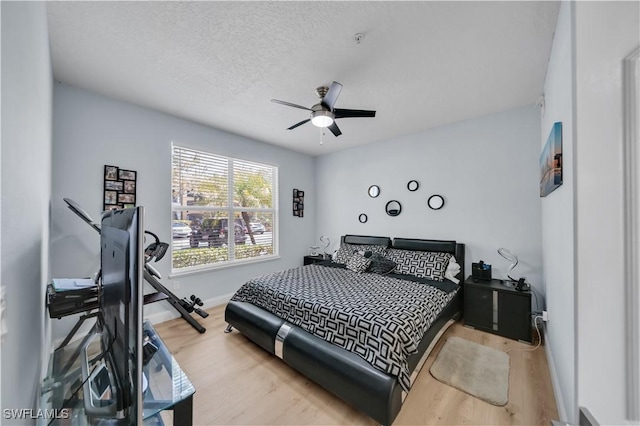 11510 Villa Grand Unit 408, Fort Myers, FL 33913 - bedroom featuring baseboards, a textured ceiling, wood finished floors, and ceiling fan