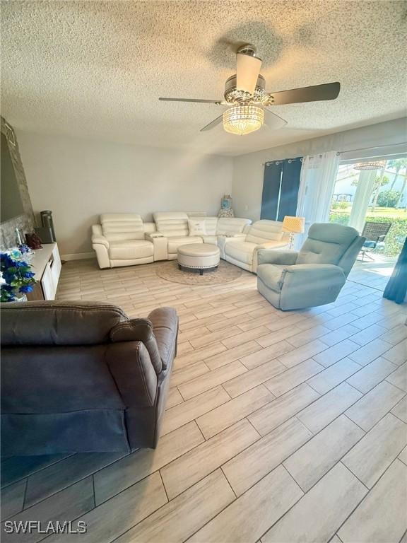 living area featuring a textured ceiling and ceiling fan