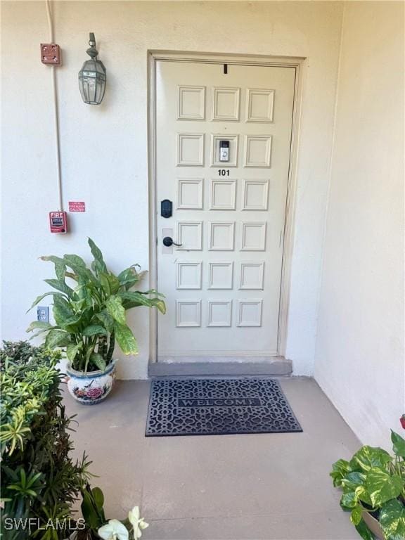 entrance to property featuring stucco siding