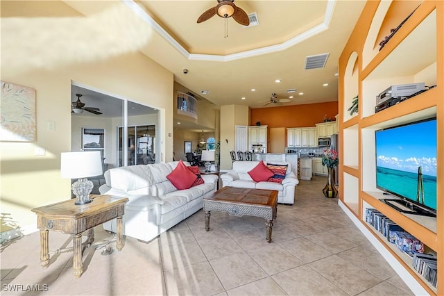416 SW 52nd St, Cape Coral, FL 33914 - living room with light tile patterned floors, visible vents, a tray ceiling, and a ceiling fan