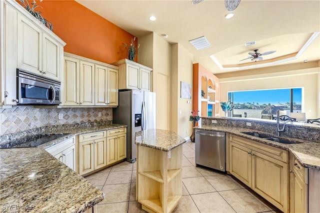 416 SW 52nd St, Cape Coral, FL 33914 - kitchen with stone counters, a raised ceiling, appliances with stainless steel finishes, and a sink