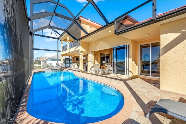 416 SW 52nd St, Cape Coral, FL 33914 - view of swimming pool featuring a lanai, a patio area, and a pool with connected hot tub