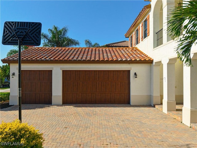 garage featuring decorative driveway