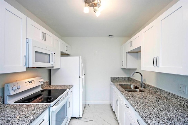 kitchen featuring marble finish floor, a sink, white cabinetry, white appliances, and baseboards