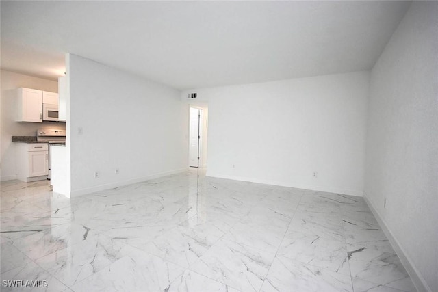 unfurnished living room with visible vents, marble finish floor, and baseboards