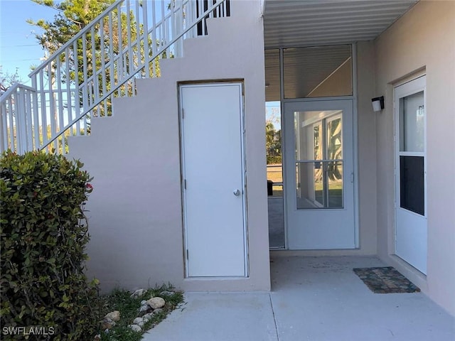 601 Periwinkle Way Unit D1, Sanibel, FL 33957 - doorway to property featuring stucco siding and a patio