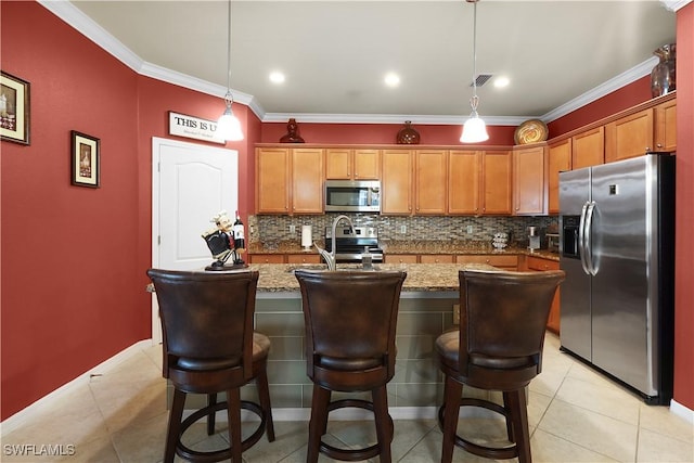 kitchen featuring visible vents, an island with sink, tasteful backsplash, appliances with stainless steel finishes, and crown molding