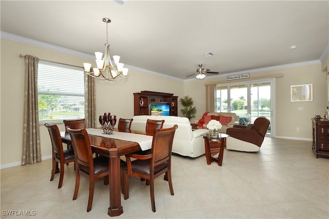 dining space with baseboards, a healthy amount of sunlight, crown molding, and ceiling fan with notable chandelier