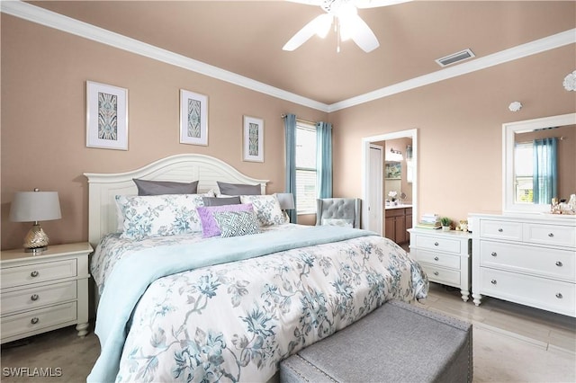 bedroom with visible vents, ensuite bath, and ornamental molding