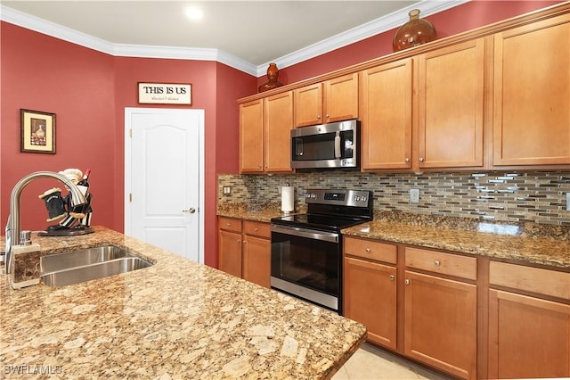 kitchen with light stone countertops, ornamental molding, a sink, appliances with stainless steel finishes, and tasteful backsplash