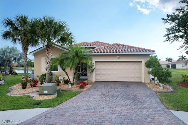 view of front facade featuring stucco siding, a front lawn, decorative driveway, a garage, and a tiled roof