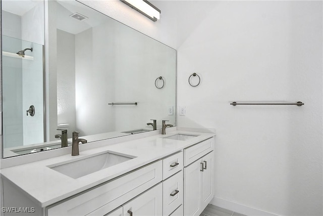 bathroom with a sink, visible vents, and double vanity