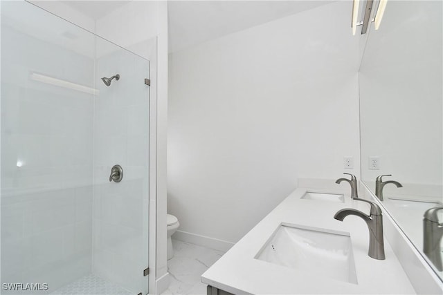 bathroom with a stall shower, marble finish floor, and a sink