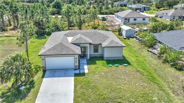 3204 69th St W, Lehigh Acres, FL 33971 - view of front of property featuring a front yard, roof with shingles, concrete driveway, stucco siding, and an attached garage