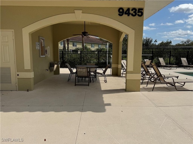 view of patio / terrace with ceiling fan and fence