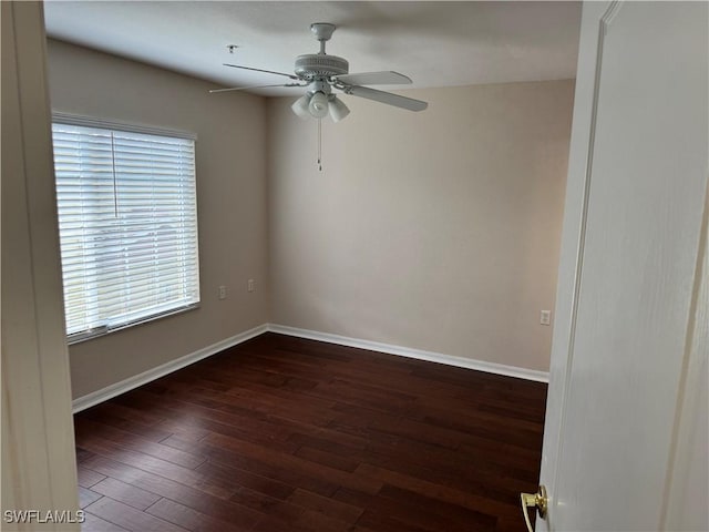 spare room with baseboards, a ceiling fan, and wood finished floors