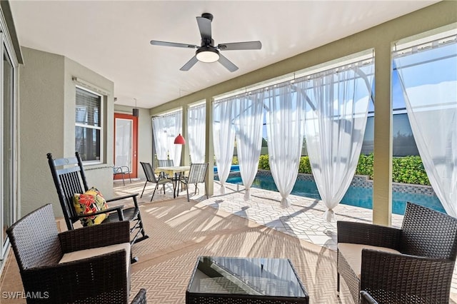 sunroom featuring ceiling fan