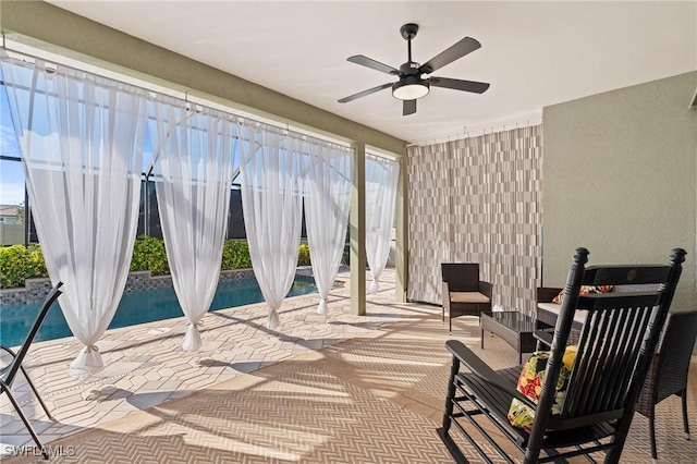 view of patio / terrace featuring stairway, a ceiling fan, and an outdoor pool