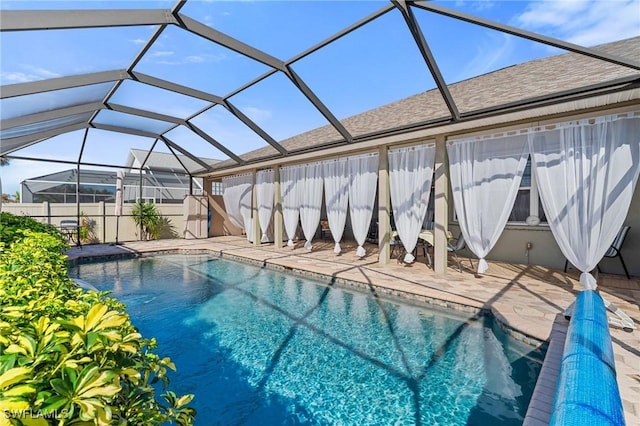 view of pool with glass enclosure, a patio area, and a fenced in pool