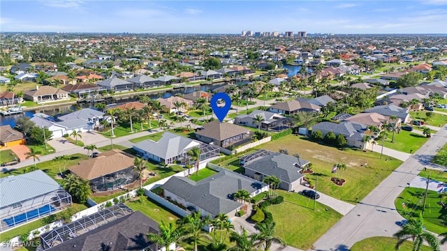 drone / aerial view with a residential view and a water view