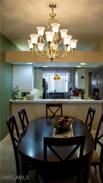 dining room with baseboards and a notable chandelier
