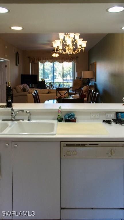 kitchen featuring dishwasher, a sink, light countertops, a chandelier, and recessed lighting