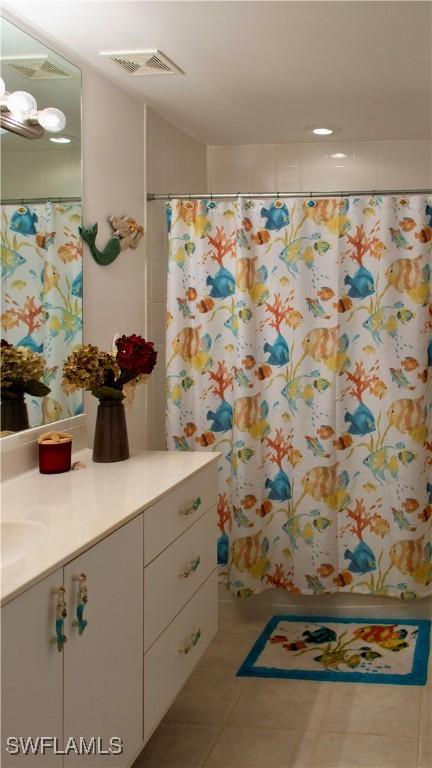 bathroom with a shower with curtain, tile patterned floors, visible vents, and vanity
