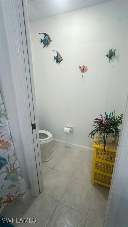 bathroom featuring toilet and tile patterned floors