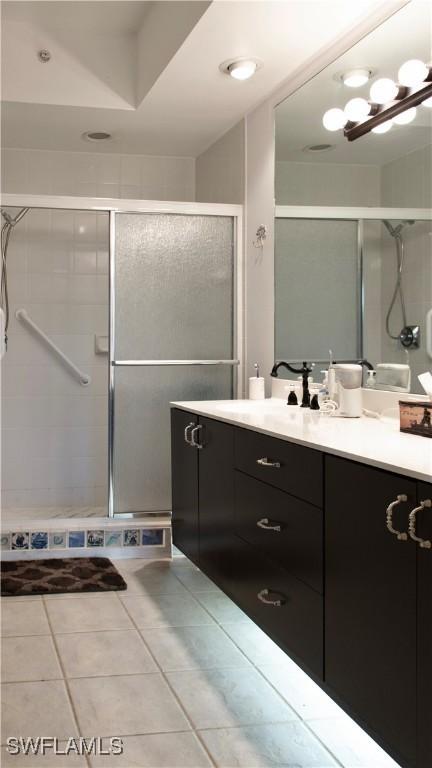 bathroom featuring vanity, tile patterned floors, and a stall shower