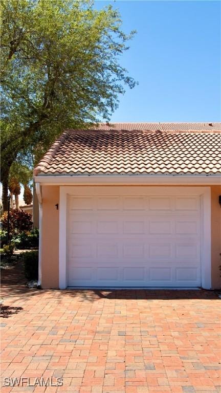 garage with decorative driveway