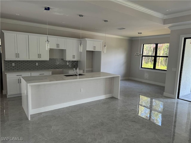 kitchen featuring white cabinets, ornamental molding, and a sink