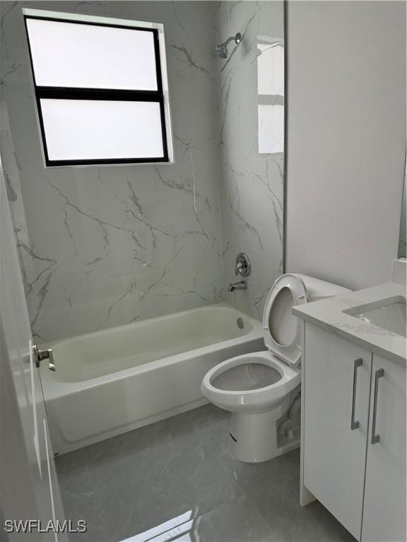 full bathroom featuring marble finish floor, toilet, vanity, and shower / tub combination