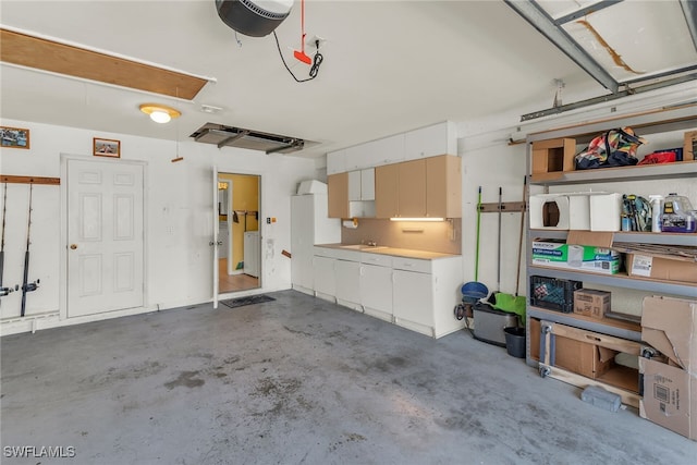 garage featuring washer / dryer and a garage door opener