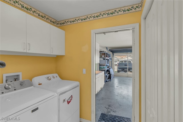 laundry room featuring cabinet space and separate washer and dryer