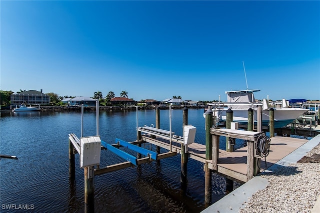 dock area with a water view and boat lift