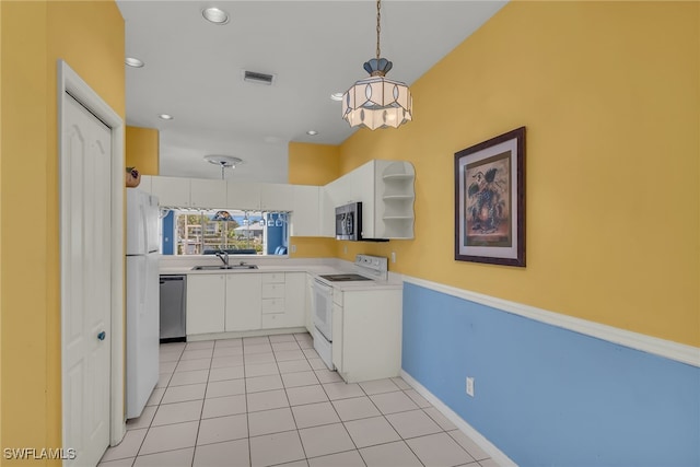 kitchen with decorative light fixtures, light countertops, white cabinets, stainless steel appliances, and a sink