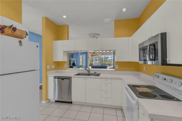 kitchen with light countertops, white cabinets, appliances with stainless steel finishes, and a sink